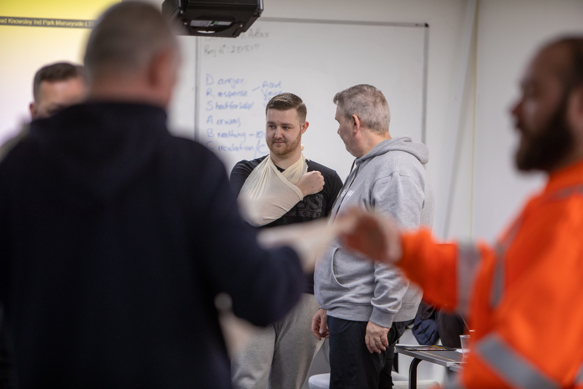 Delegate practising an arm sling on an Adapt first aid course